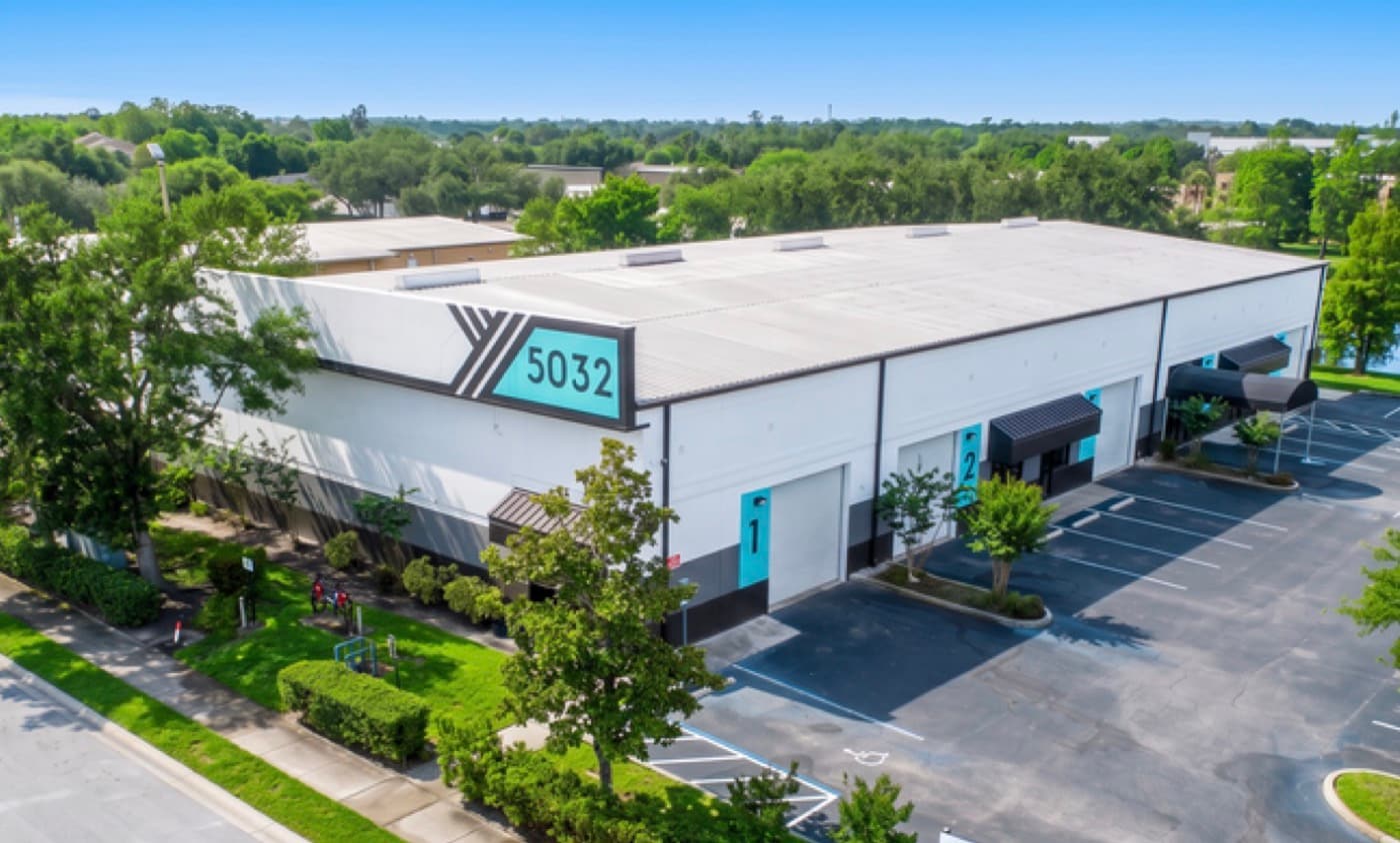5032 Forsyth Commerce Rd. after renovation, with new paint and teal signage